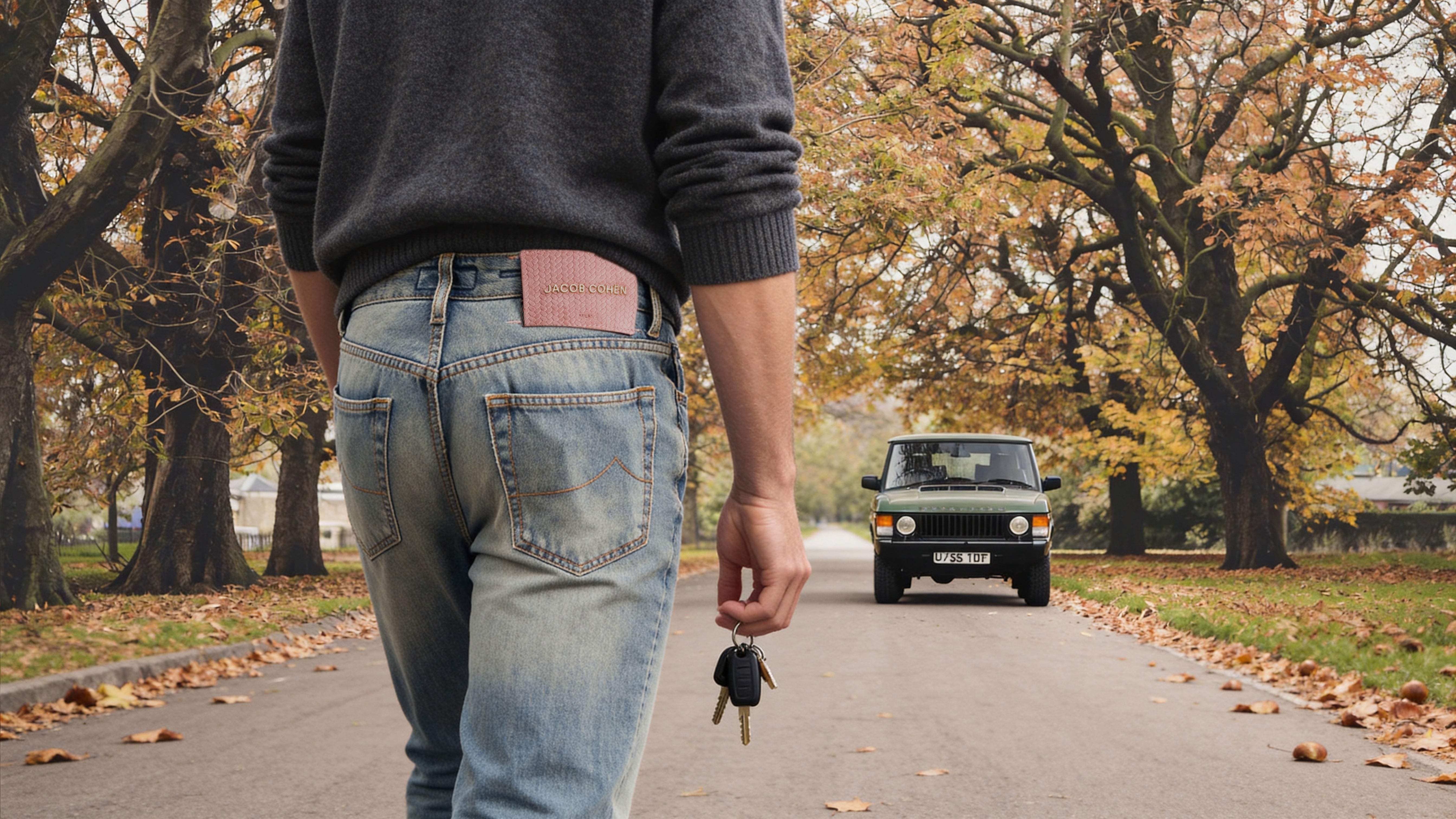 Jacob Cohen Zwembroeken – man in Jacob Cohen jeans loopt in de herfst naar zijn klassieke Range Rover